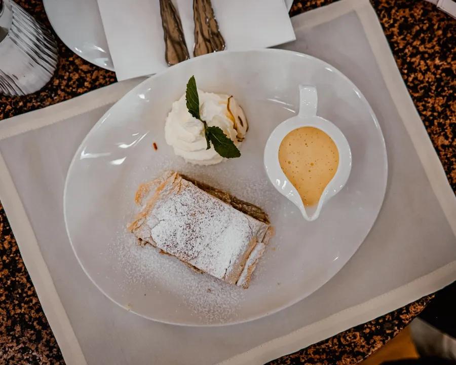 Apfelstrudel with icing sugar and vanilla sauce