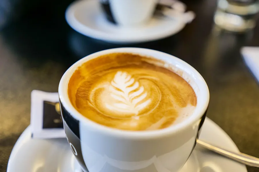 Melange coffee with foam art on a Viennese cafe table