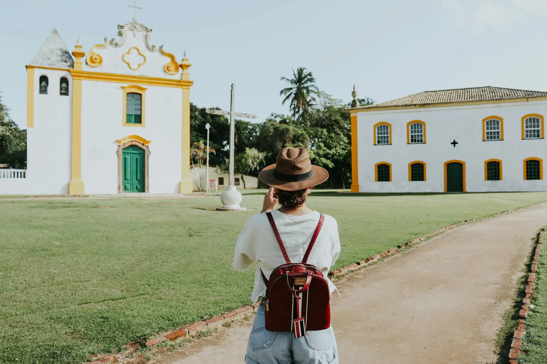 Traveler taking photos of a historic church in Porto Seguro, Bahia, Brazil.