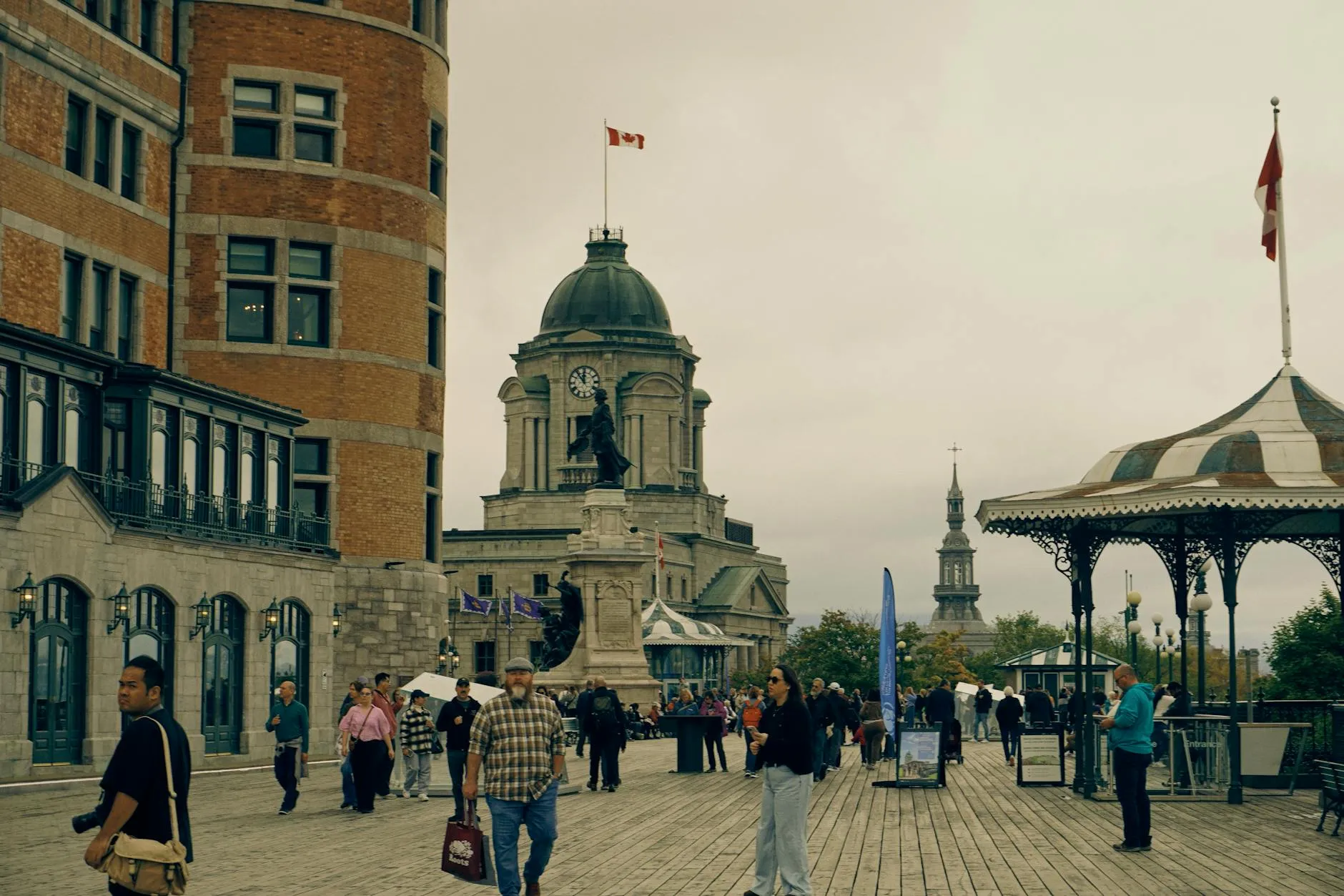 Explore the bustling Promenade in Old Quebec City with iconic architecture and lively crowd on a cloudy day.