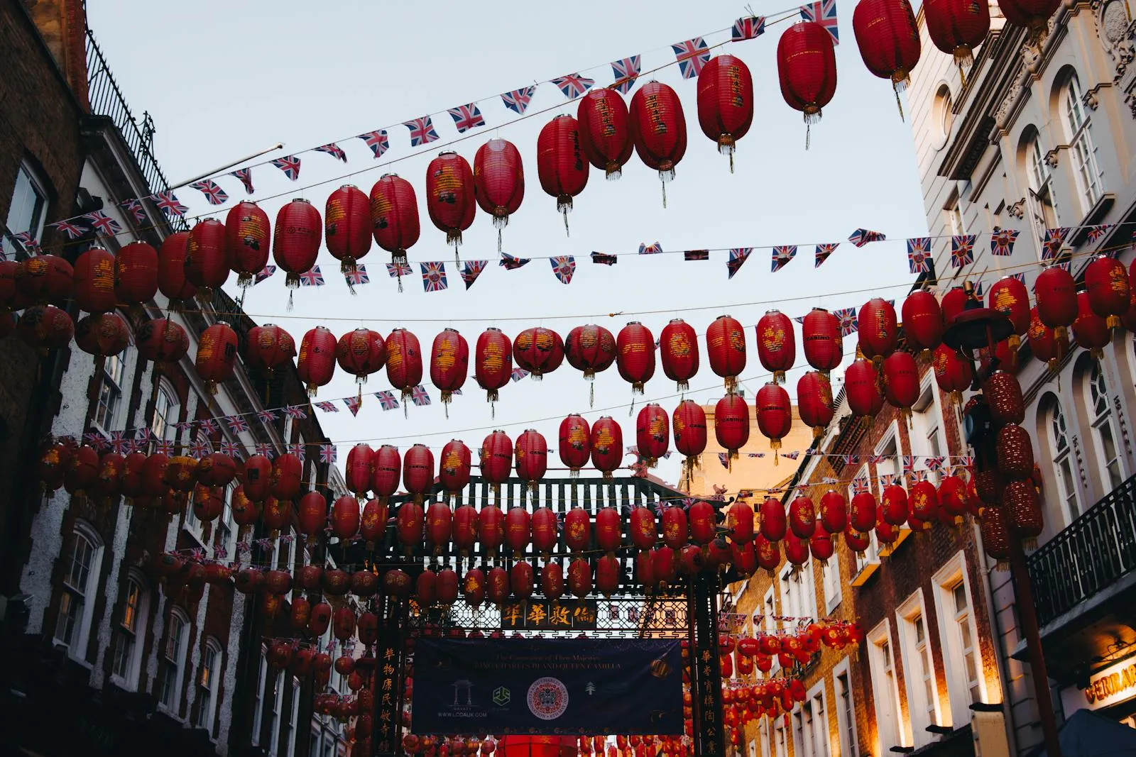 Red lanterns hanging over a crowded street during Chinese New Year celebrations