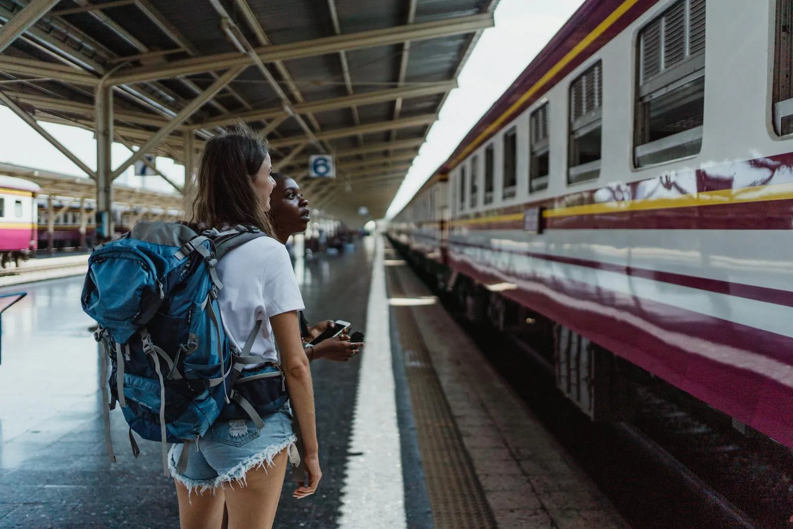 Traveller with backpack looking at departure board in a Chinese train station