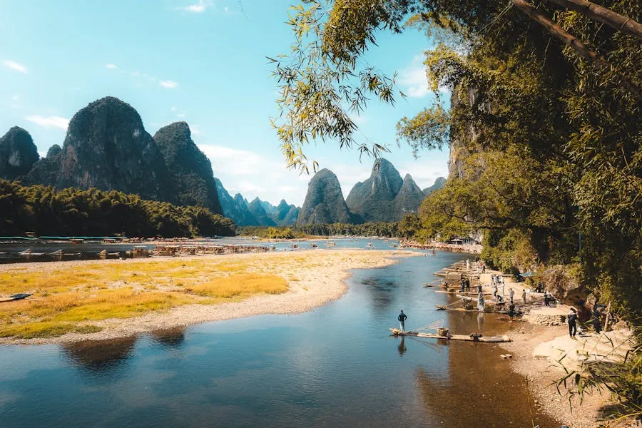 Li River with bamboo raft and karst limestone peaks under misty skies