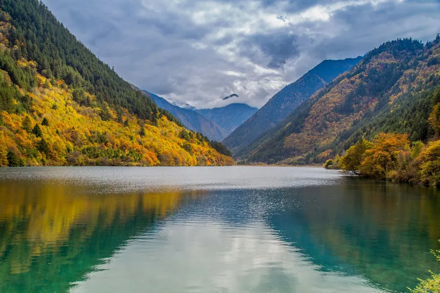 Crystal-clear turquoise lake surrounded by autumn foliage at Jiuzhaigou