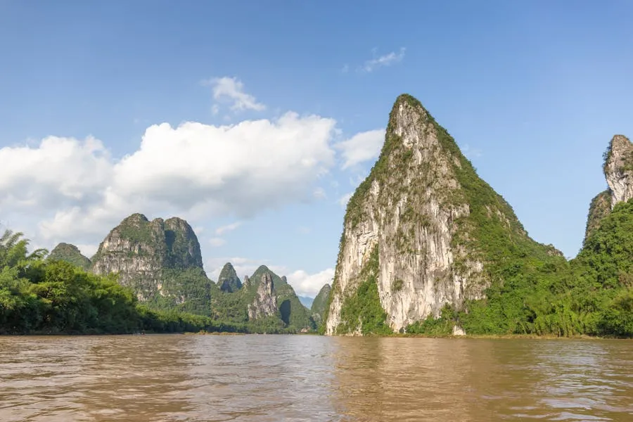 Li River cruise boat passing between karst peaks near Yangshuo