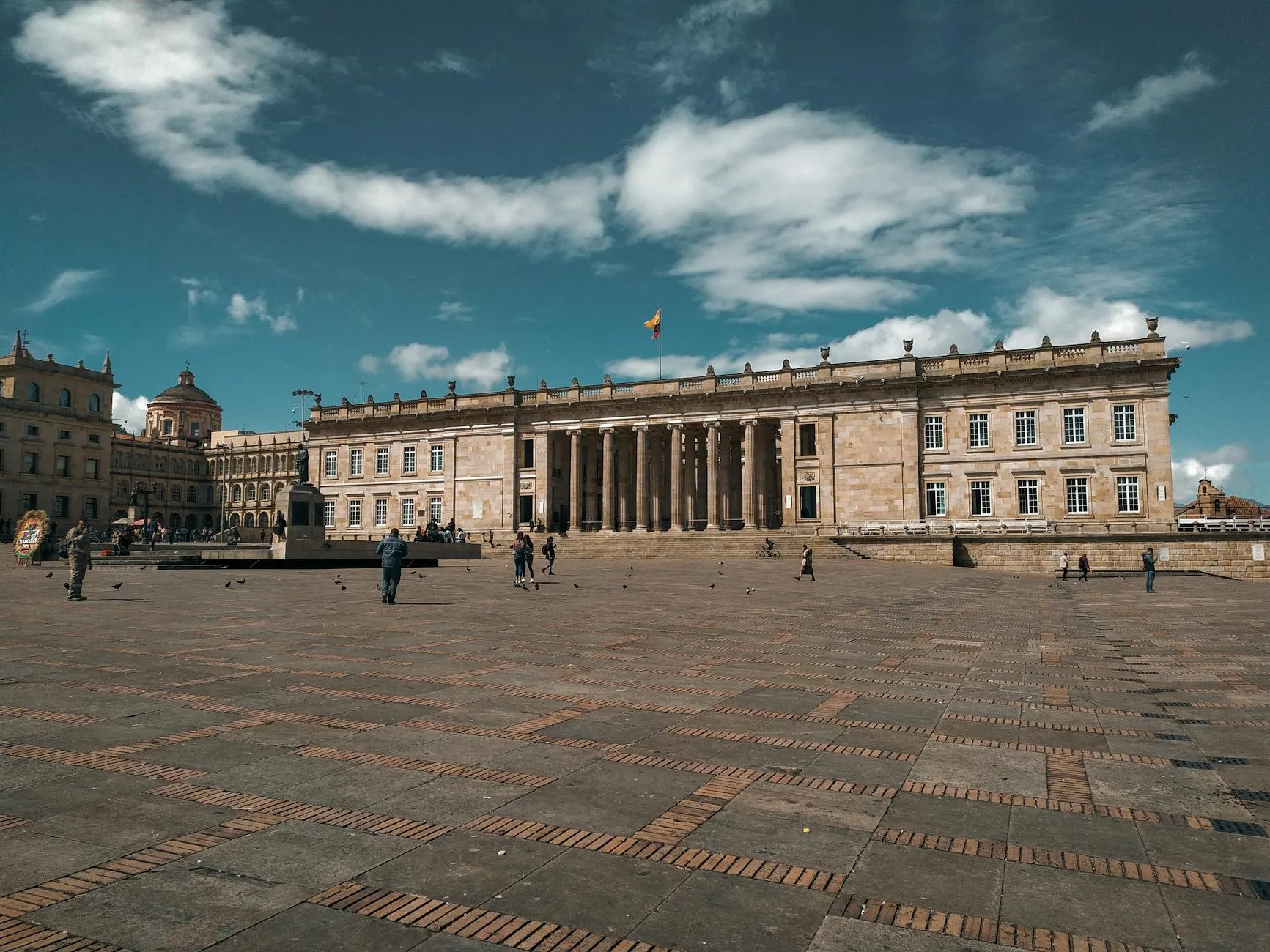 Glimpse the grand facade of Bolívar Square in Bogotá under a bright blue sky.