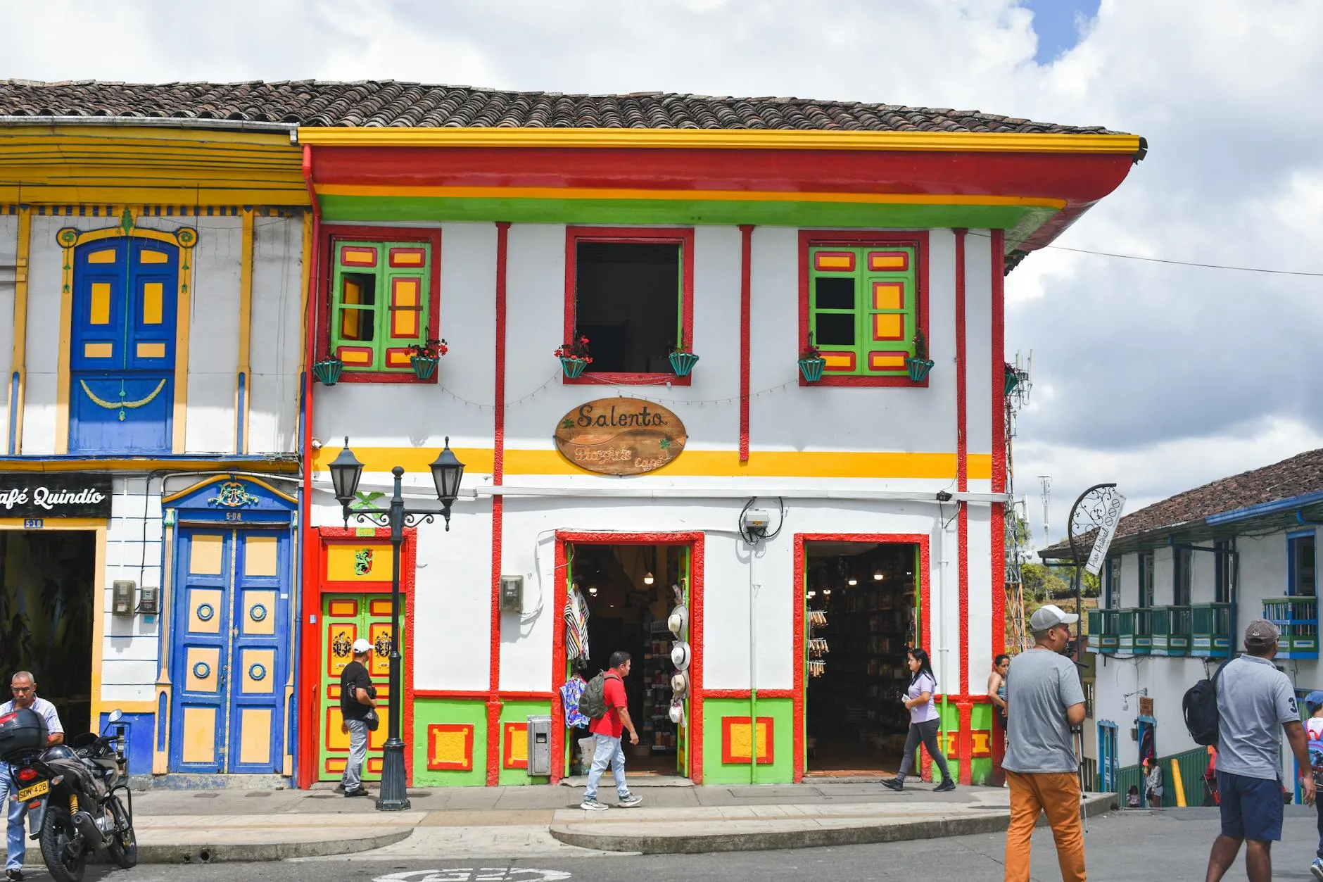 Vibrant colonial architecture on a bustling street in Salento, Colombia.