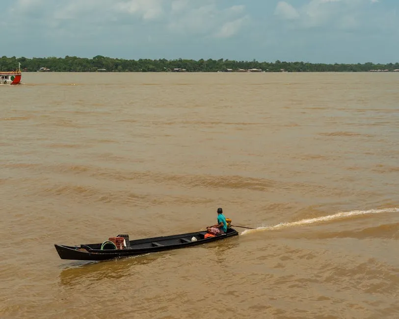 Congo River with boats and Kinshasa skyline in background