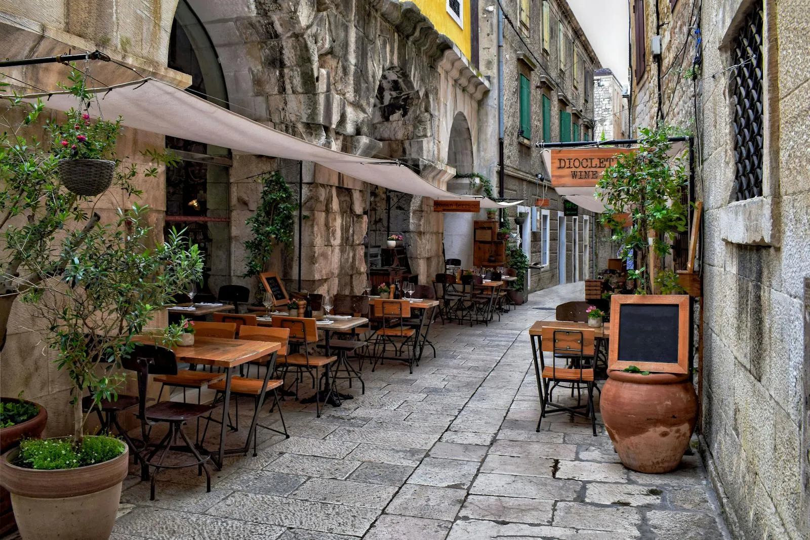 Traditional Croatian konoba restaurant with stone walls and wooden tables
