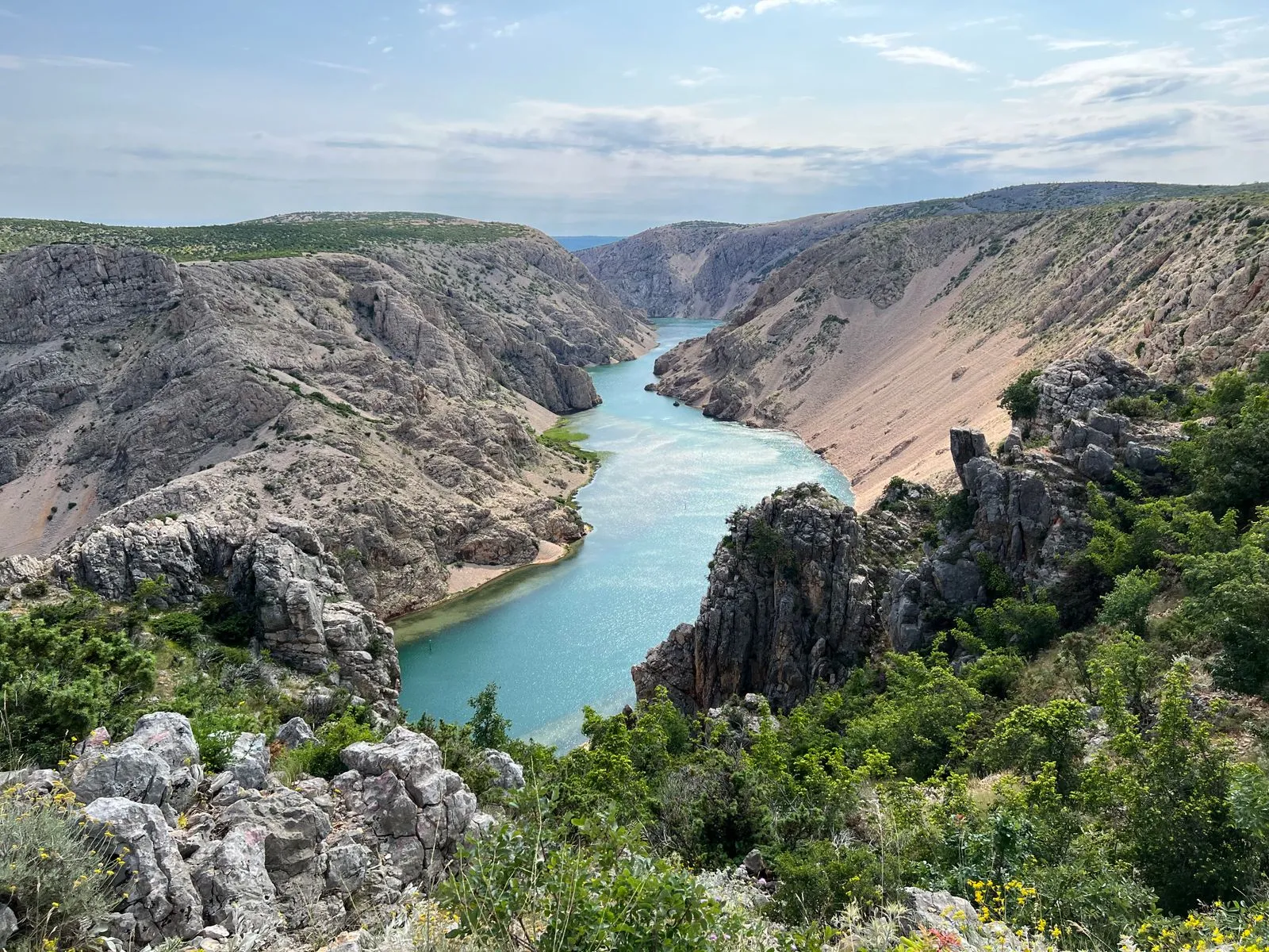 Hiking trail along dramatic Croatian canyon cliffs with Adriatic views