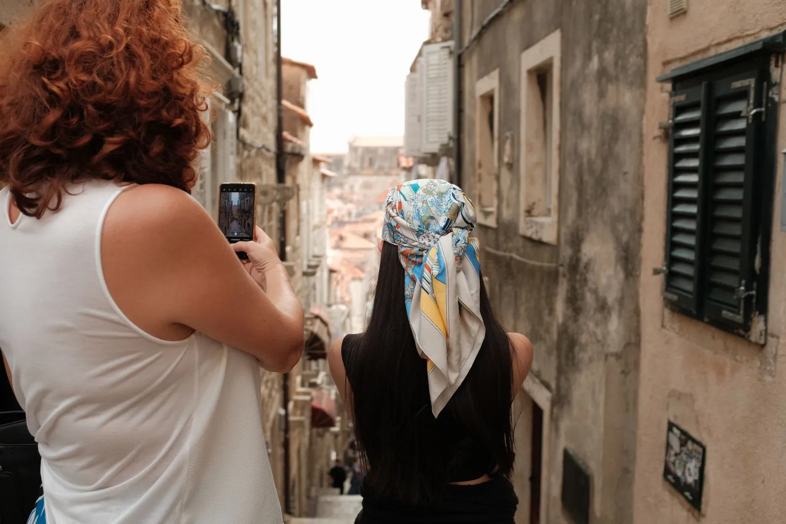 Traveller exploring a quiet Croatian old town alley