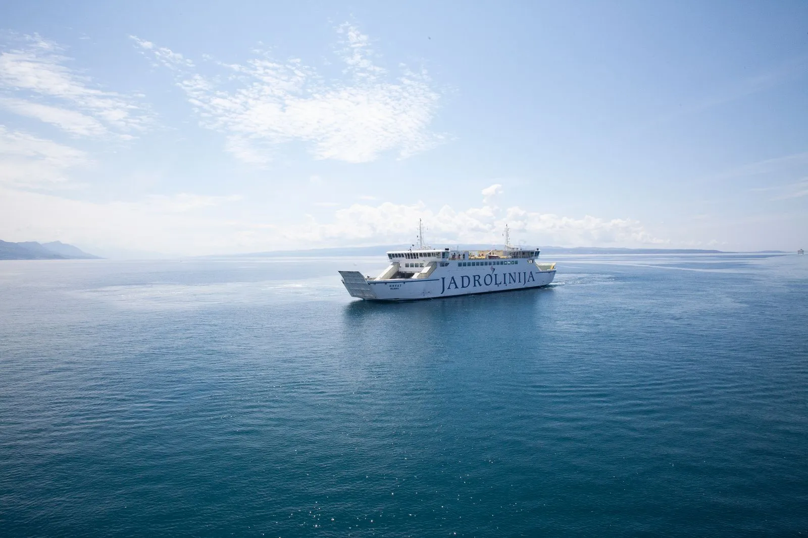 Jadrolinija ferry departing Croatian harbour with islands in background