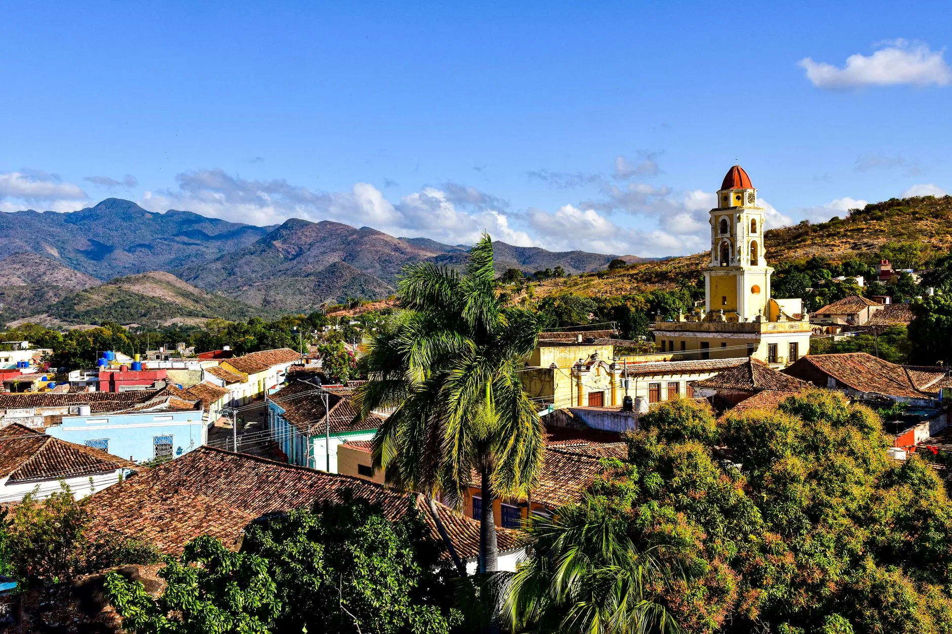 A beautiful view of Trinidad, Cuba, featuring mountains and colonial architecture.