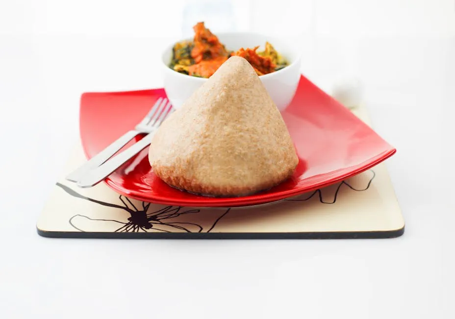 White fufu ball served alongside stew
