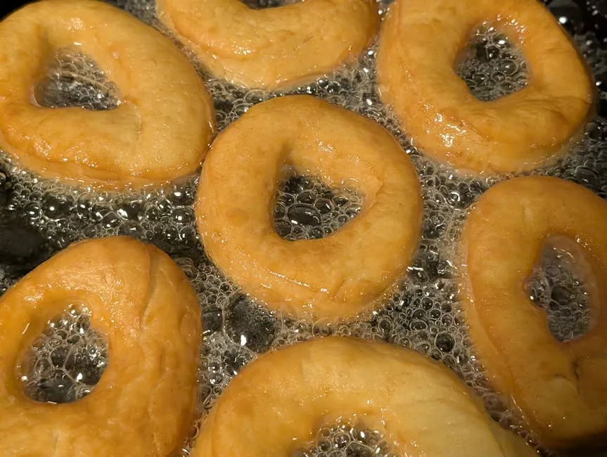 Golden fried mikate (beignets) on a plate