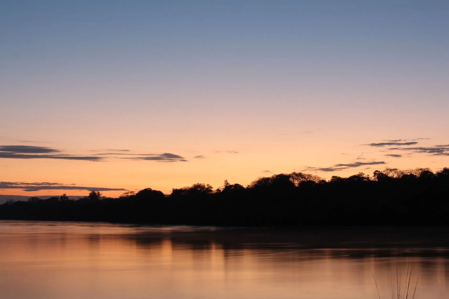 Sunset over the Congo River with silhouetted boats