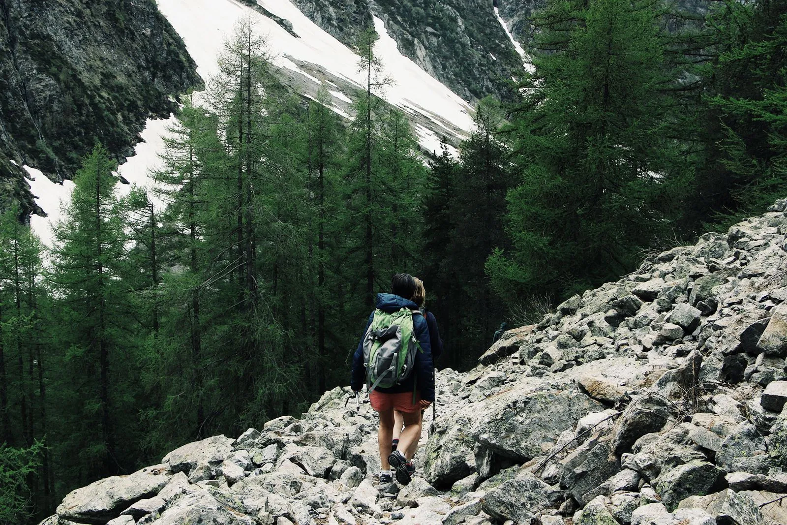 Hiker on a mountain trail with Mont Blanc in the background