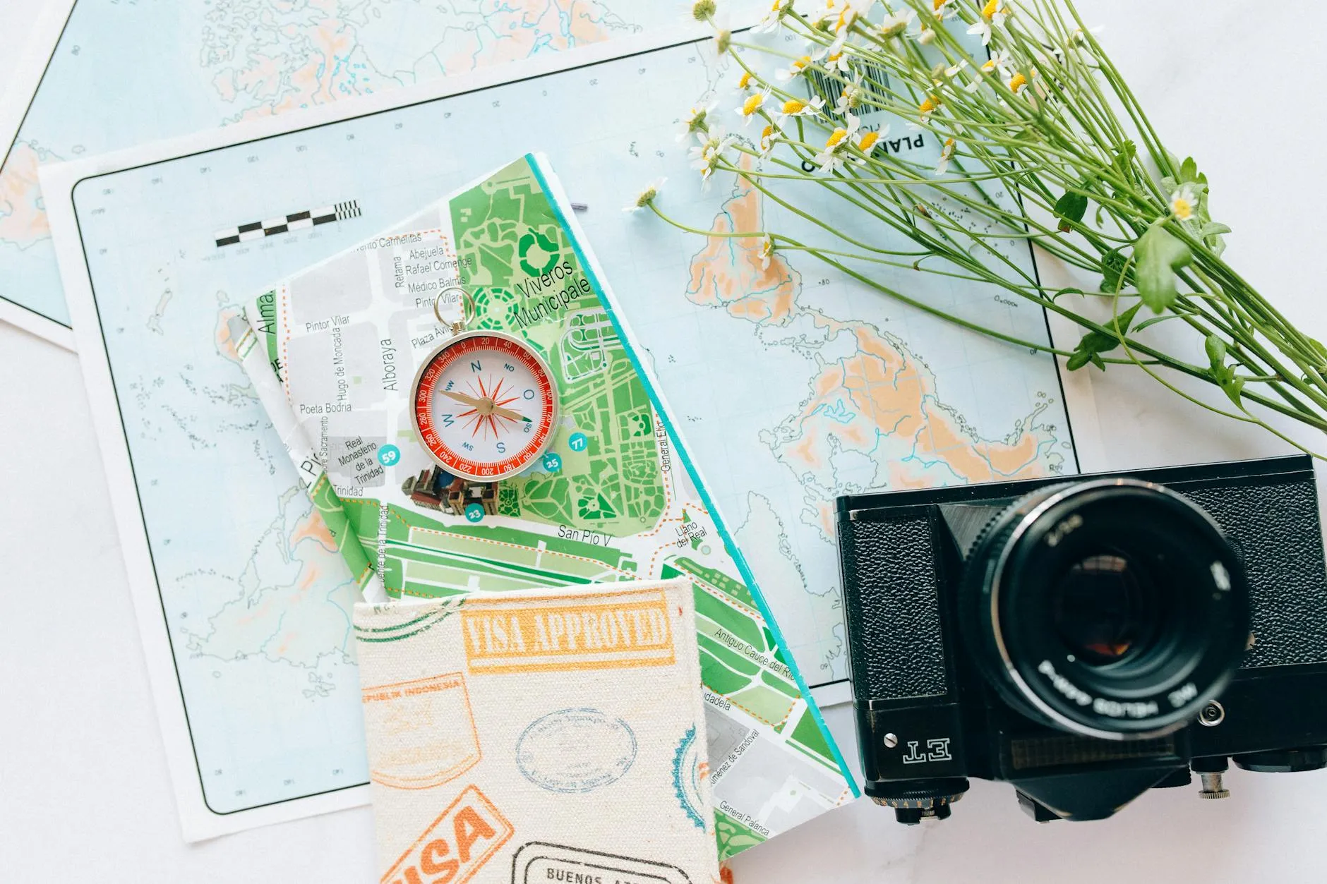 Travel essentials laid out on a map