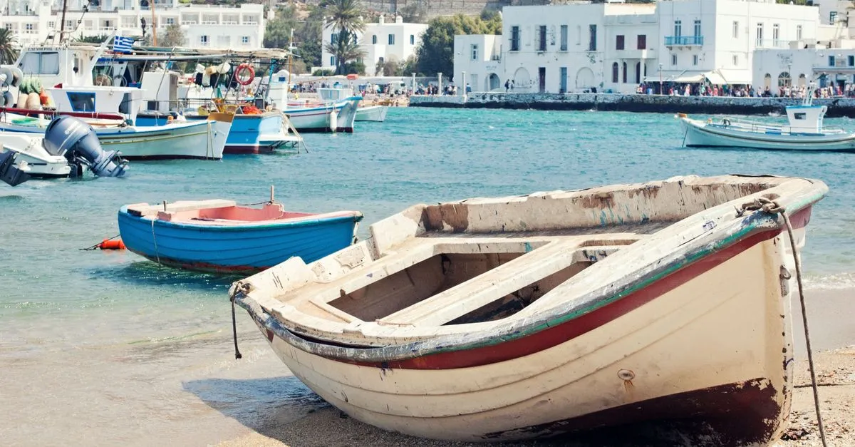 Greek island harbour in spring with colourful flowers and fishing boats