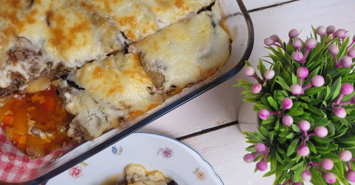 Baked moussaka in a ceramic dish with golden b&eacute;chamel top