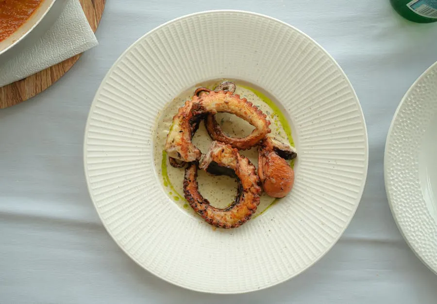 Grilled octopus tentacles on a plate at a seaside taverna