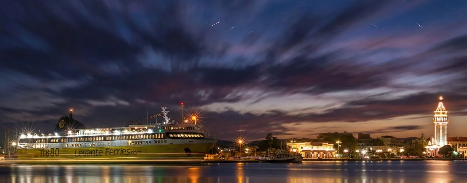 Greek ferry departing a harbour with island in the background