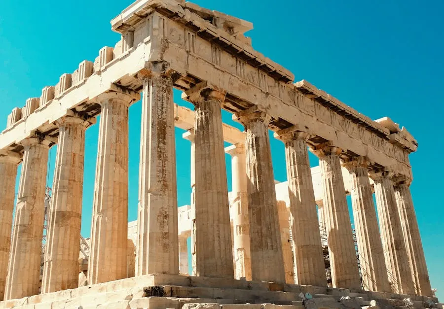 The Parthenon atop the Acropolis in Athens against a blue sky
