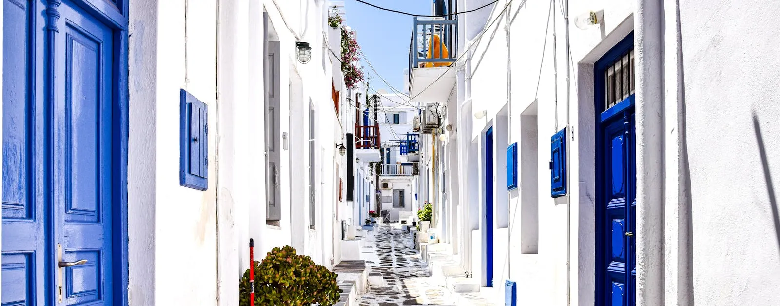 Narrow whitewashed street in a Greek island village
