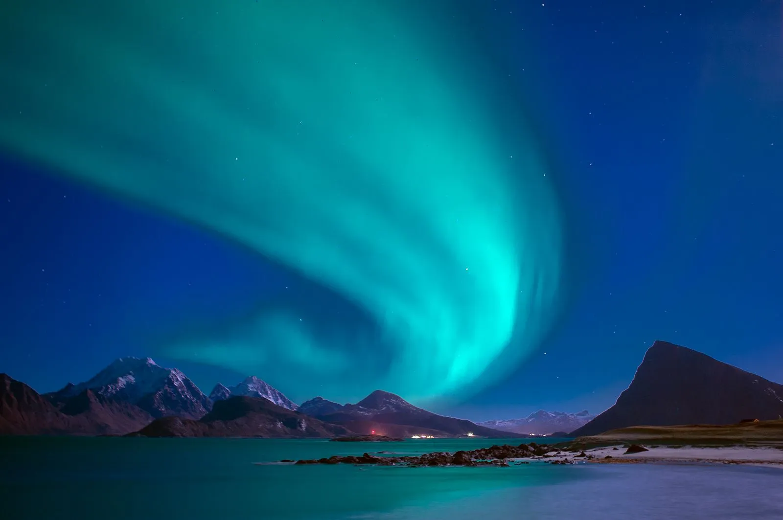 Northern lights dancing over a snowy Greenlandic landscape