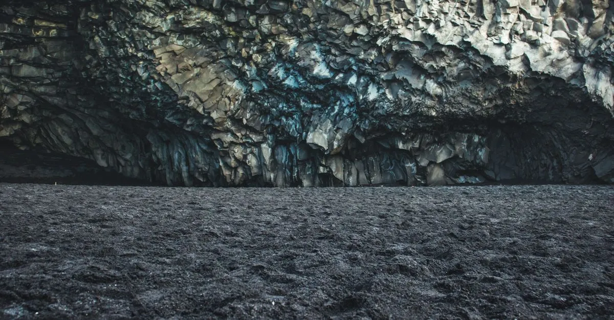 Geometric basalt column formations inside a cave at Reynisfjara black sand beach