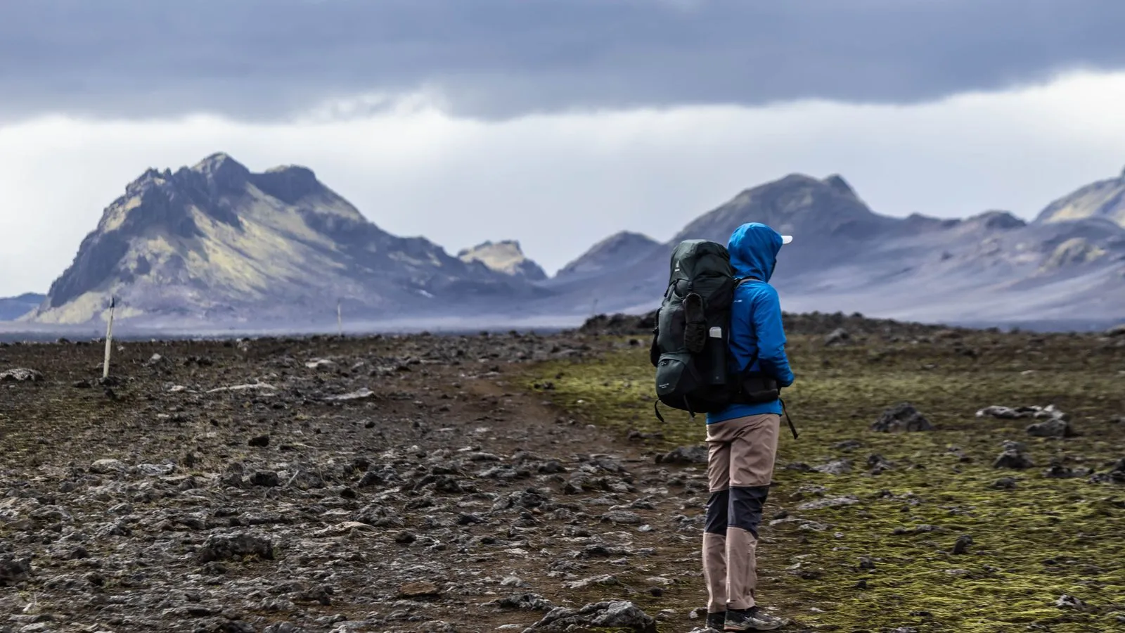 Hikers on a mountain trail through the Icelandic wilderness with panoramic views