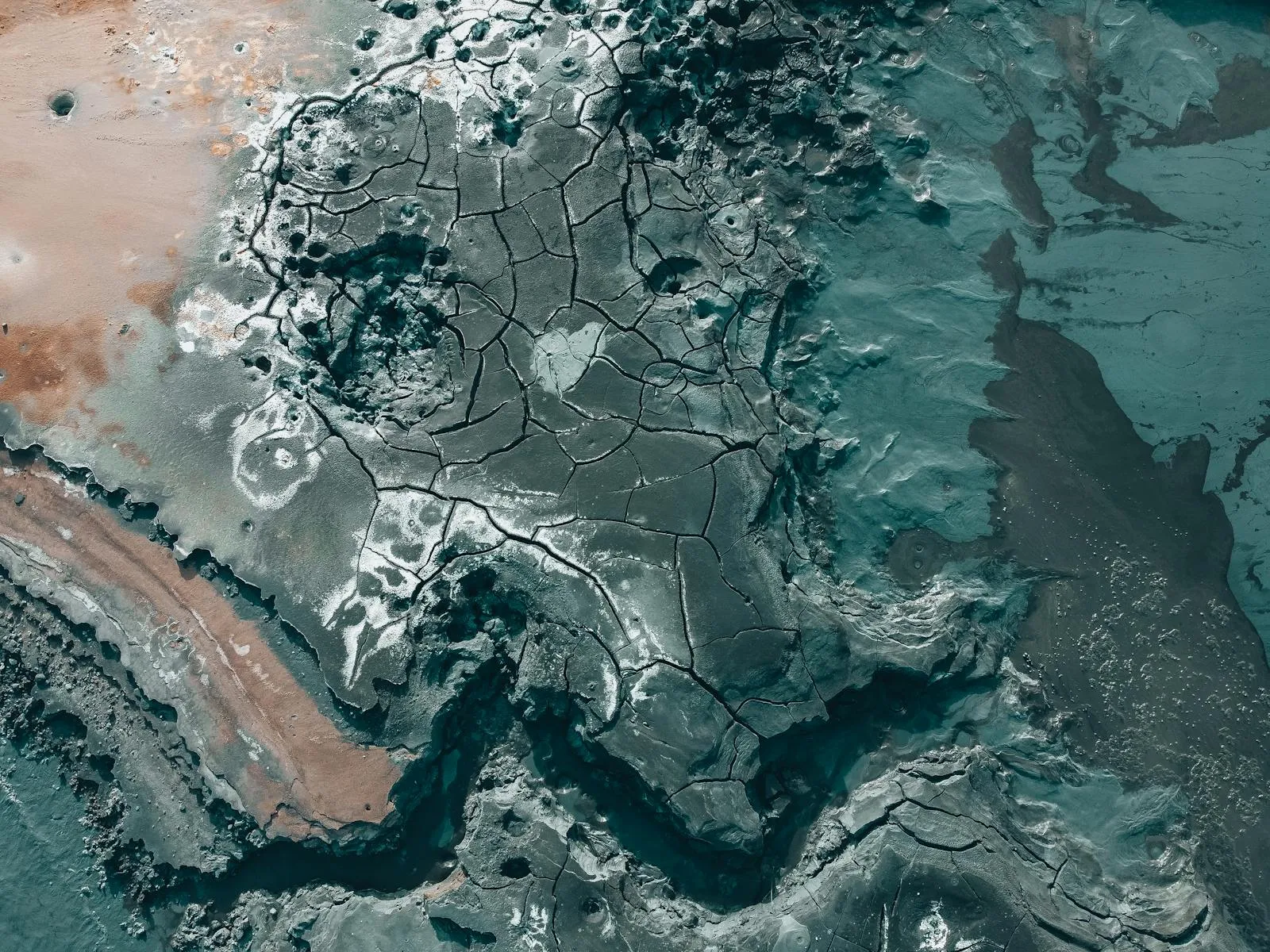 Dramatic aerial view of Iceland volcanic terrain showing cracked lava fields and geological formations