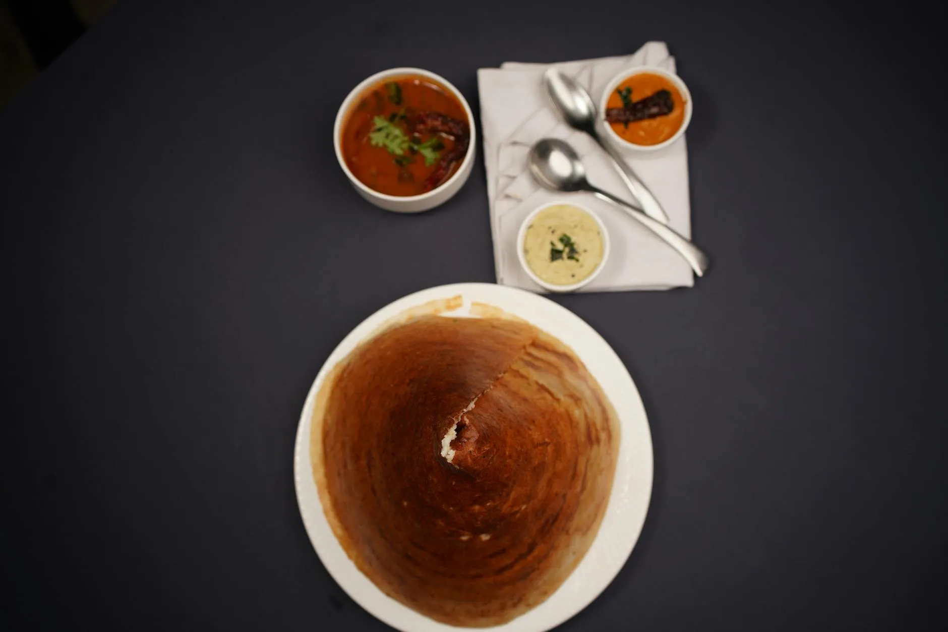 Crispy dosa served with sambar and coconut chutney