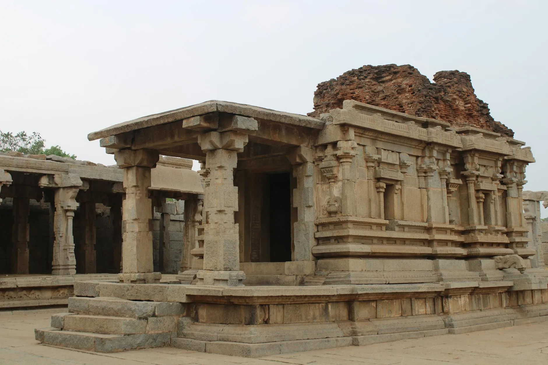 Ancient Vijayanagara ruins scattered across rocky landscape in Hampi