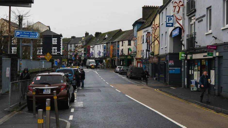 Colourful shopfronts and buskers on a street in Galway's Latin Quarter