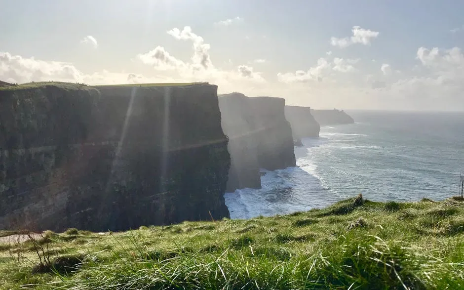 The Cliffs of Moher stretching along the Atlantic coast under dramatic clouds