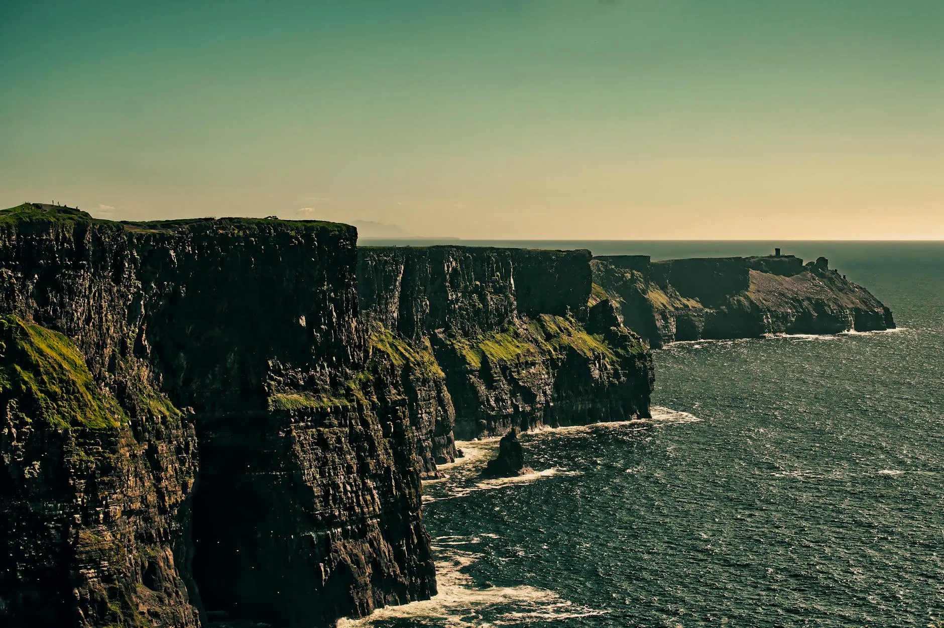 Sunset over the Atlantic Ocean seen from the Irish west coast with silhouetted cliffs