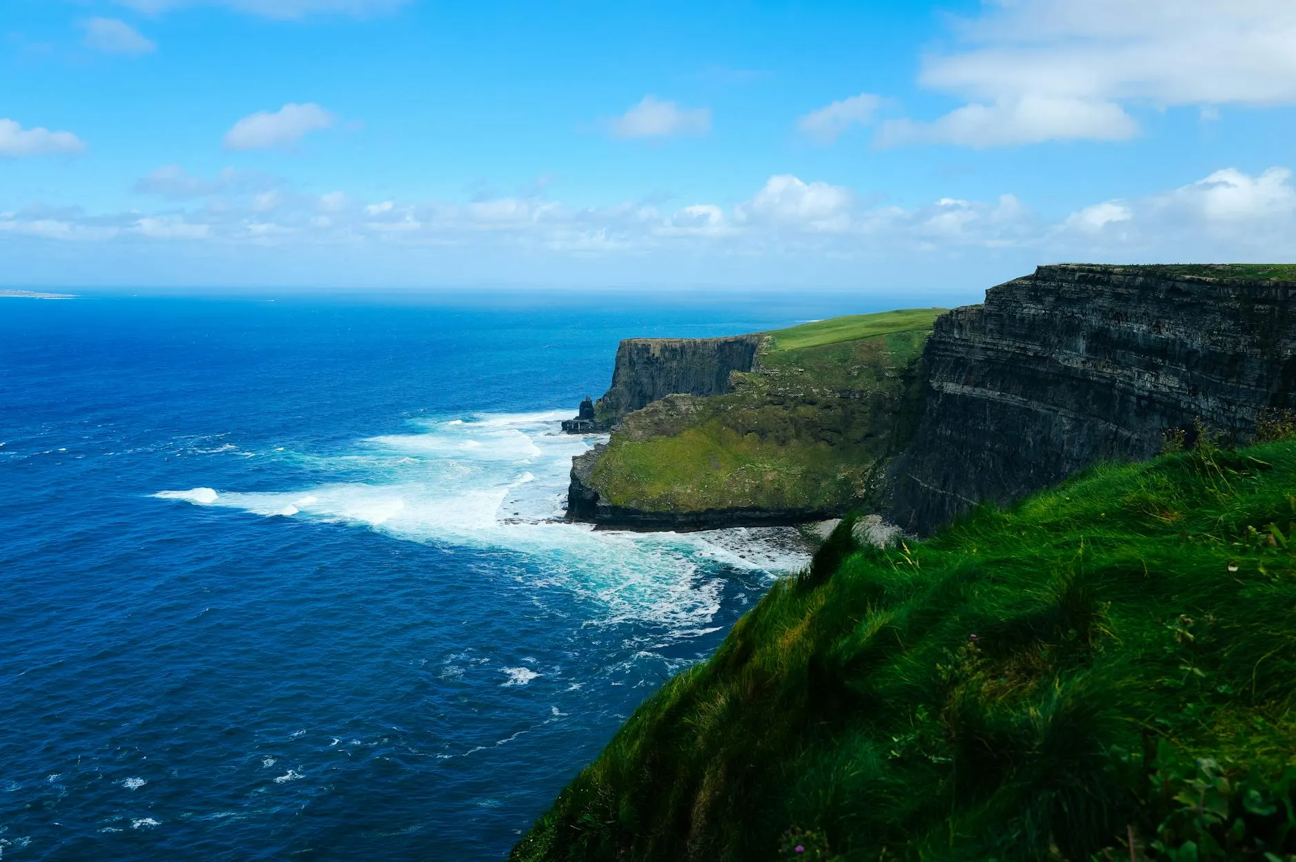 The Cliffs of Moher rising dramatically above the Atlantic Ocean on a clear day