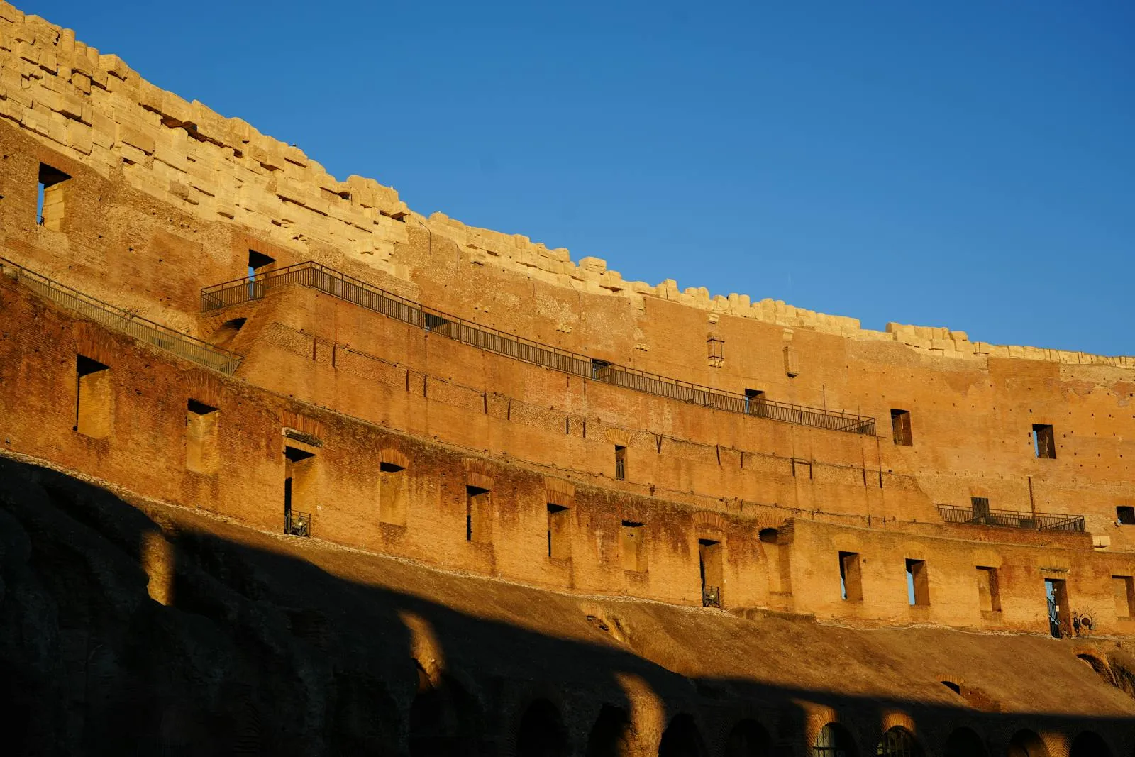Panoramic view of Rome with the Colosseum and ancient ruins under golden light