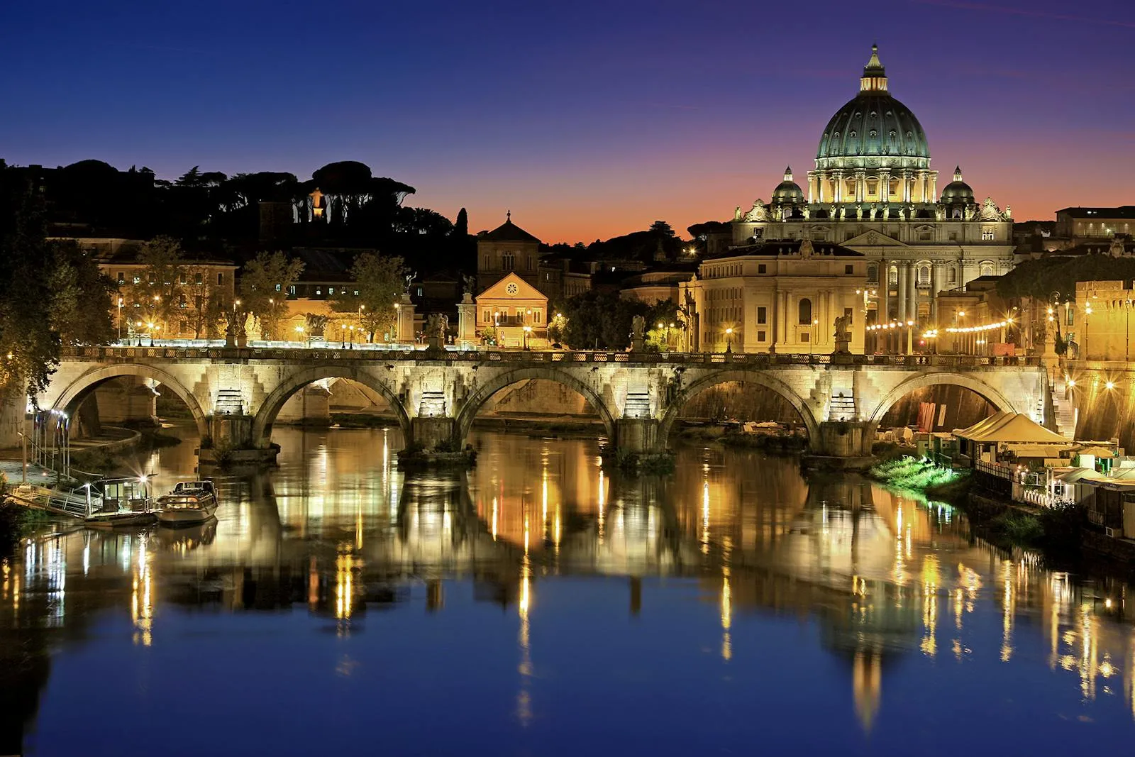 St Peters Basilica dome viewed from across the Tiber River at twilight