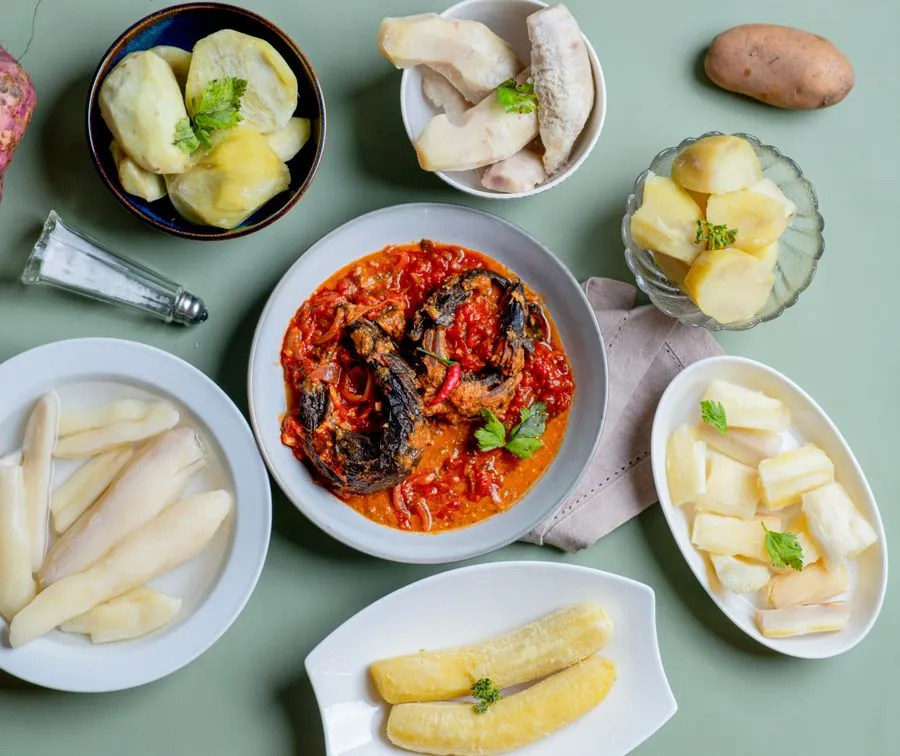 Plate of ravitoto with shredded cassava leaves and pork
