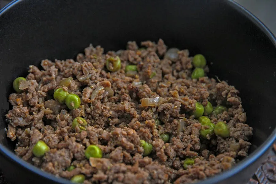 Bowl of romazava stew with mixed greens and meat