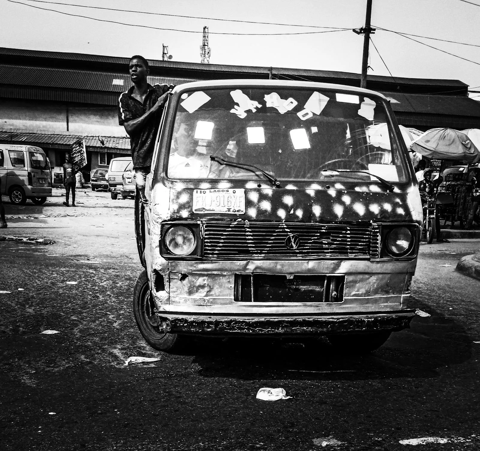 Colourful taxi-brousse minibus on a red laterite road