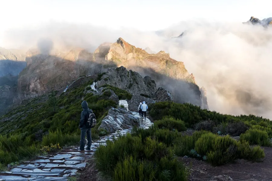 PR1.2 stone steps ascending to Pico Ruivo summit above the clouds