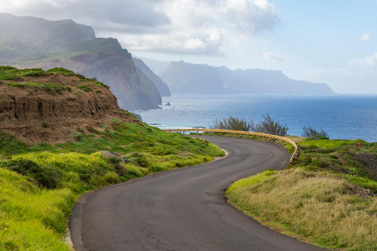 Winding mountain road through Madeira's interior with panoramic ocean views