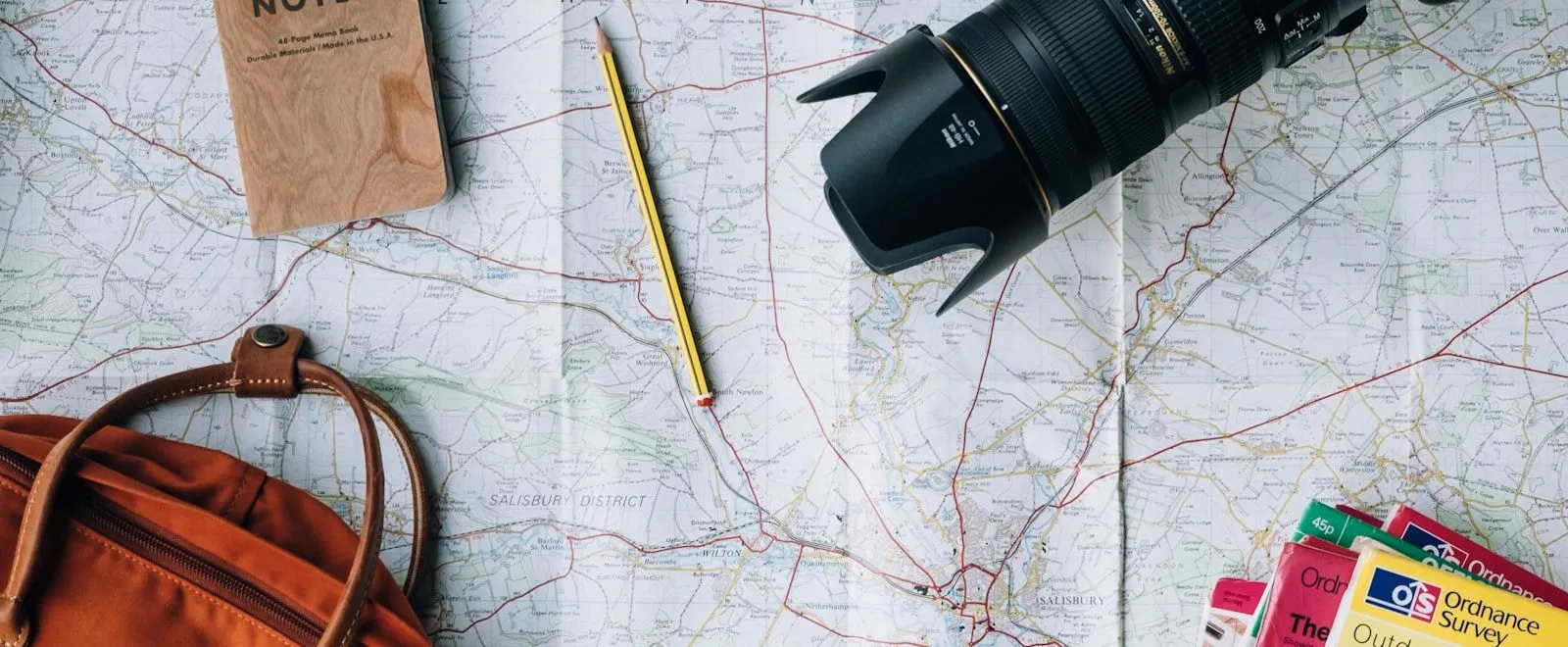 Travel planning with map and documents spread out