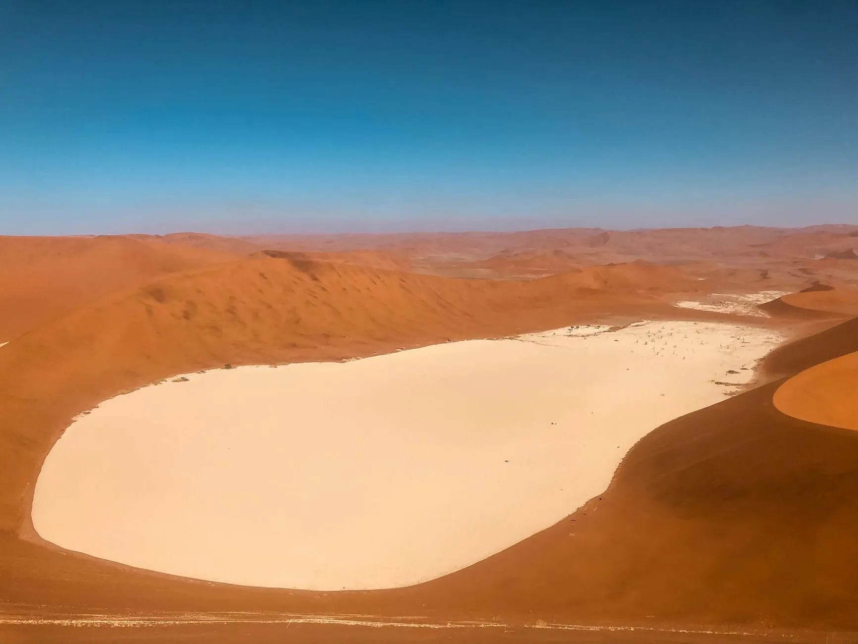 Aerial view of the Namibian landscape with red desert dunes