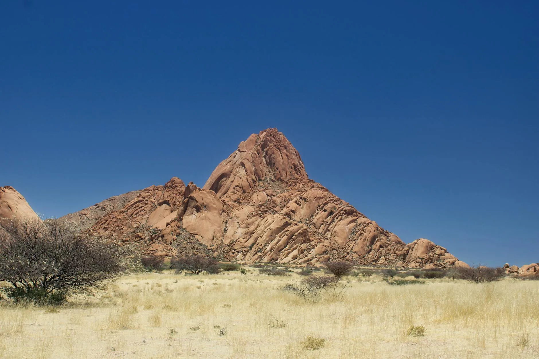 Explore the majestic rock formations of Spitzkoppe under clear blue skies in Namibia's Erongo region.