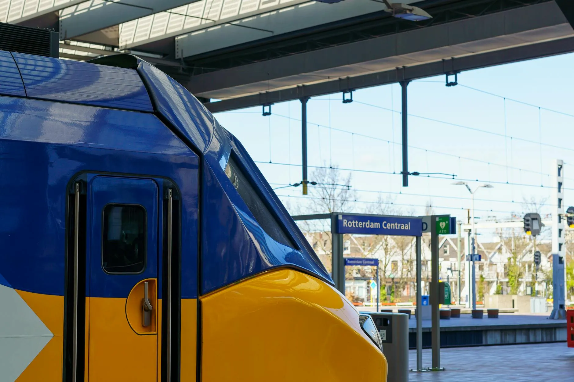 Yellow-blue NS intercity train at a Dutch railway station