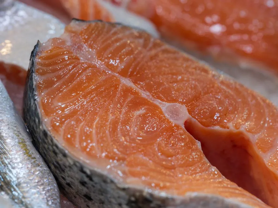 Fresh Norwegian salmon fillet on ice at a fish market
